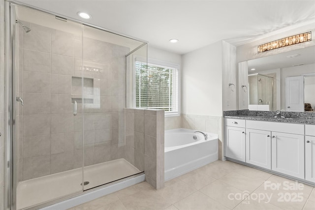 bathroom featuring vanity, separate shower and tub, and tile patterned floors