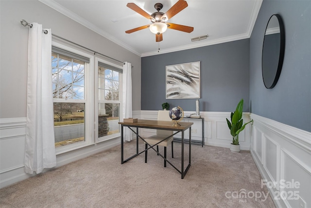 carpeted office space featuring ceiling fan and ornamental molding