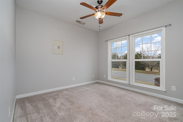 carpeted spare room featuring ceiling fan