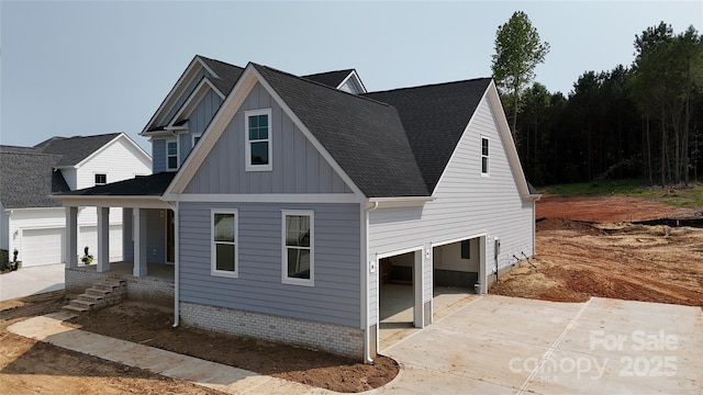 4251 Candlewood Dr, Sherrills Ford, NC 28673 - view of front of property featuring board and batten siding, a porch, concrete driveway, roof with shingles, and a garage