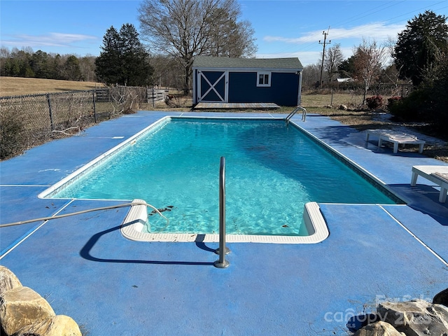 view of swimming pool featuring a storage unit