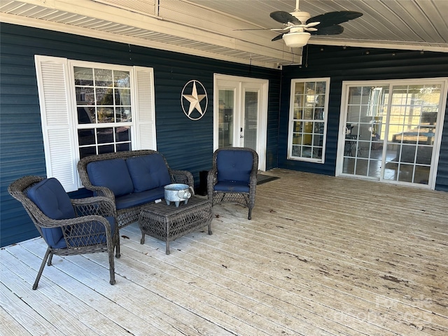 wooden deck featuring outdoor lounge area and ceiling fan