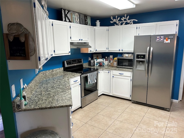 kitchen with light tile patterned flooring, white cabinetry, stone countertops, and appliances with stainless steel finishes