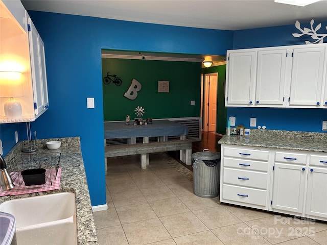 kitchen featuring sink, white cabinets, and light tile patterned floors