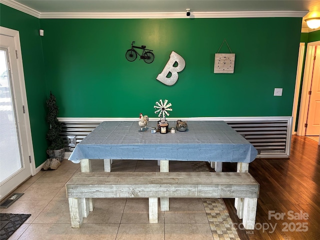 unfurnished dining area with tile patterned floors and ornamental molding