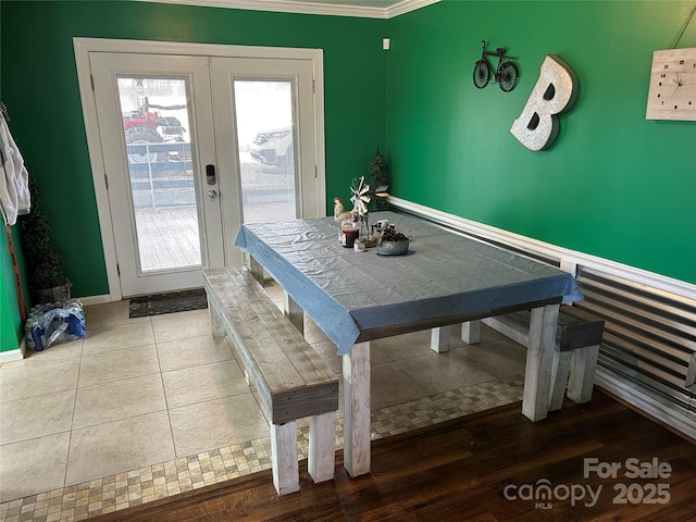 dining room featuring french doors and crown molding