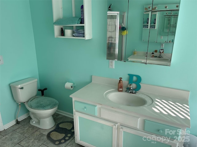 bathroom with vanity, toilet, and tile patterned floors