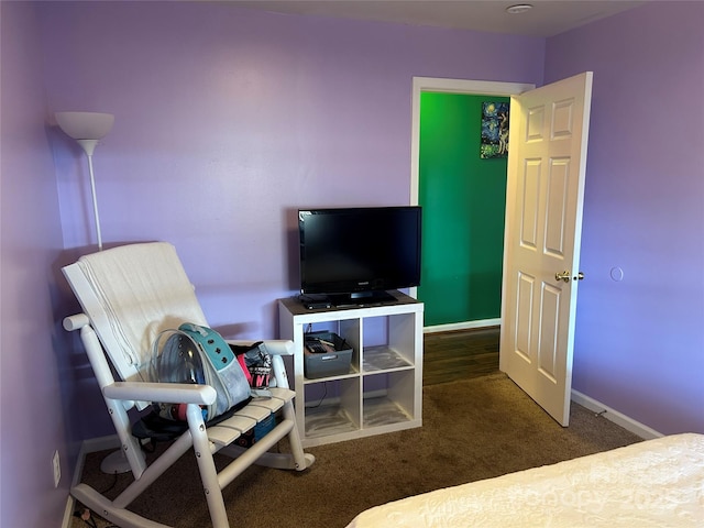 bedroom featuring dark carpet