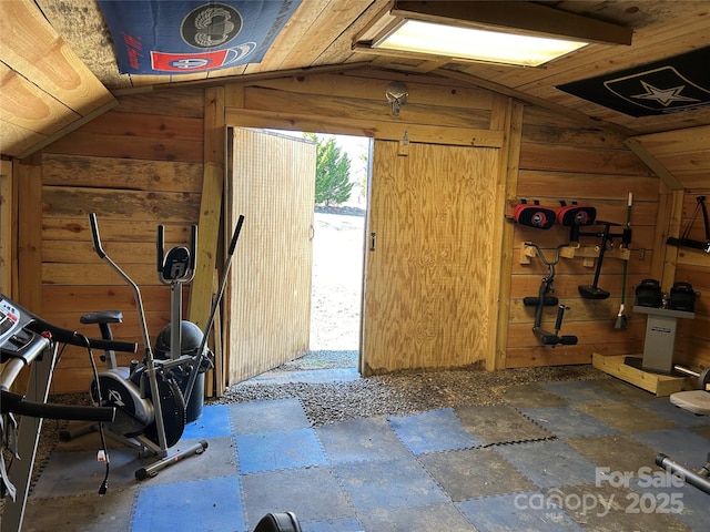 interior space featuring wooden walls and vaulted ceiling