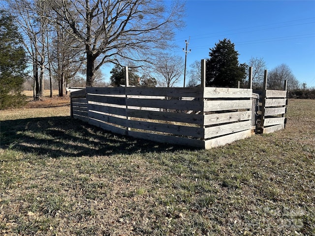 view of gate featuring a yard