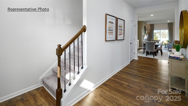 stairway featuring wood-type flooring