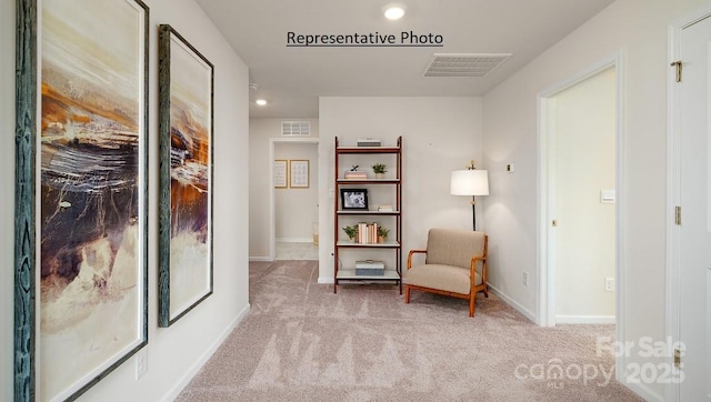 living area featuring light colored carpet