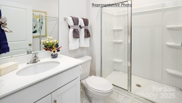 bathroom featuring toilet, walk in shower, and vanity