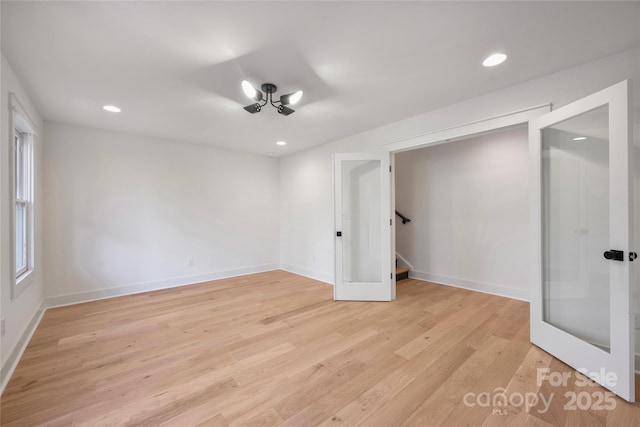 unfurnished bedroom with french doors and light hardwood / wood-style floors