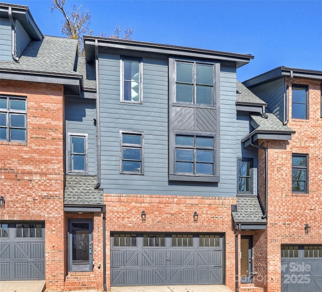 multi unit property featuring a garage