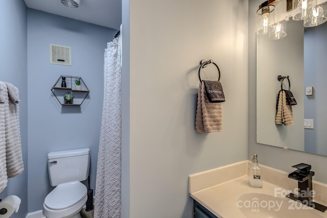 bathroom featuring toilet and vanity