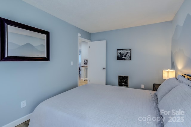 bedroom with wood-type flooring