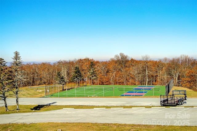 view of community featuring tennis court