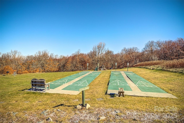 view of home's community with a yard