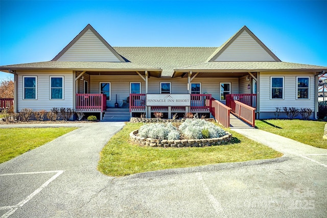 farmhouse with a front lawn and a porch