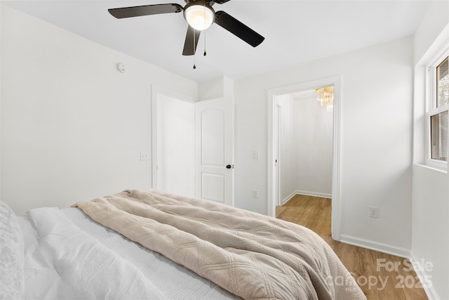 bedroom with ceiling fan and light hardwood / wood-style flooring