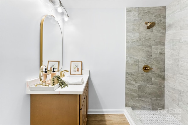 bathroom with vanity and tiled shower