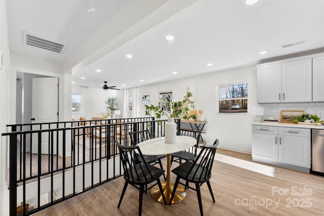 dining space with ceiling fan, plenty of natural light, and light hardwood / wood-style flooring