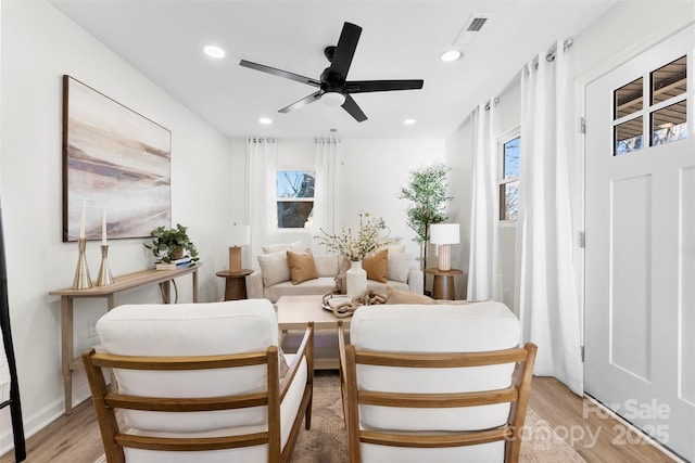 sitting room featuring ceiling fan and light wood-type flooring