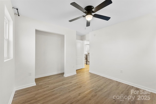 unfurnished bedroom with ceiling fan and light wood-type flooring