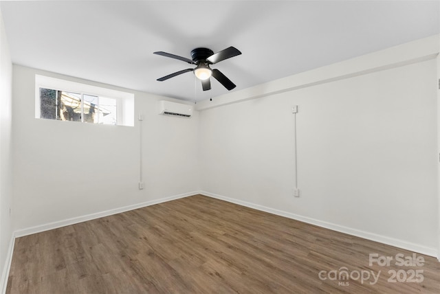 empty room with ceiling fan, a wall mounted AC, and wood-type flooring