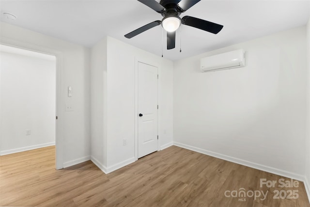 unfurnished bedroom featuring ceiling fan, a closet, hardwood / wood-style floors, and a wall mounted air conditioner