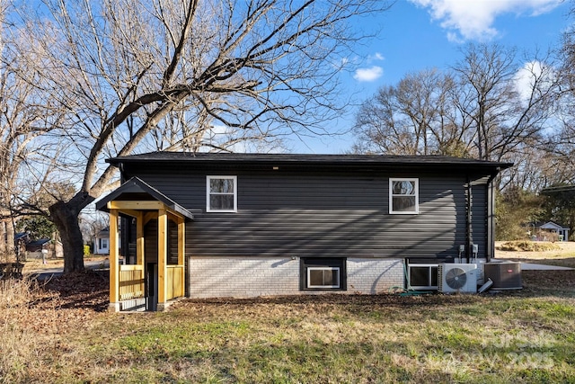 view of property exterior featuring a lawn and ac unit