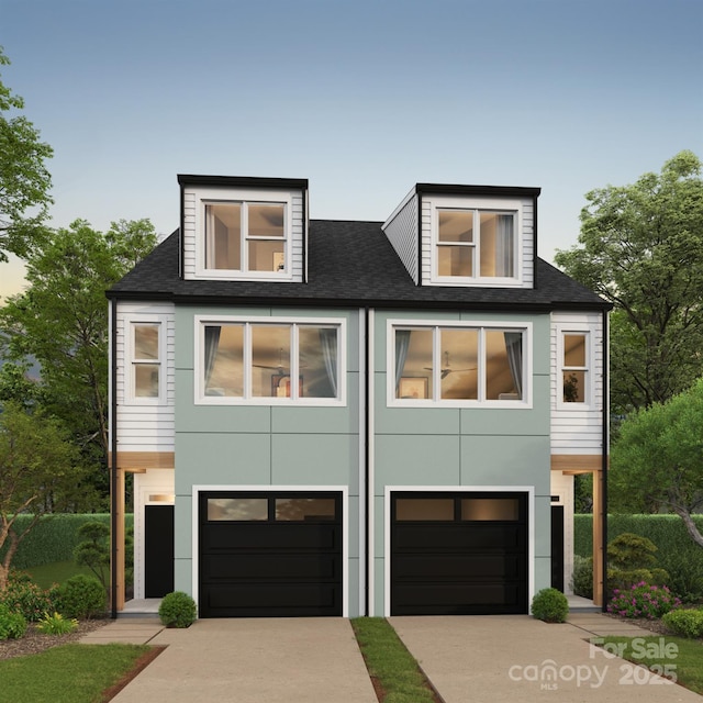 contemporary home featuring driveway and an attached garage