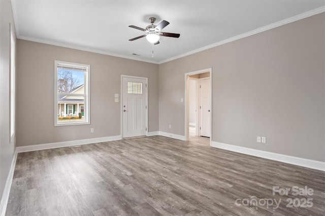 spare room with hardwood / wood-style flooring, ceiling fan, and ornamental molding