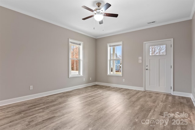 foyer with hardwood / wood-style floors, ceiling fan, and ornamental molding