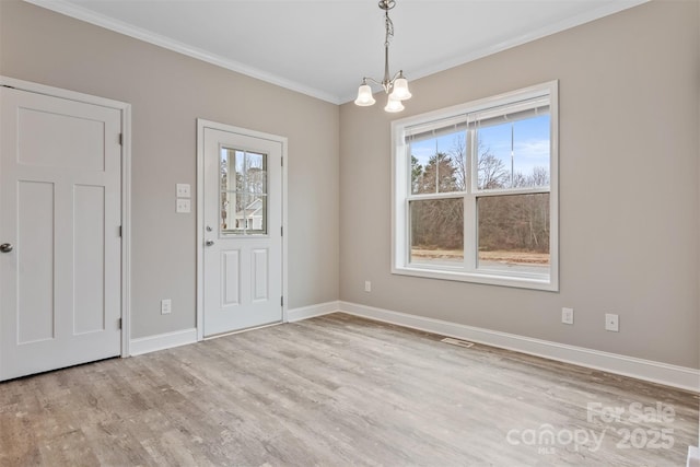 interior space featuring ornamental molding, a chandelier, and light wood-type flooring