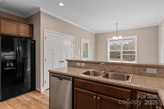 kitchen featuring sink, dishwasher, ornamental molding, and black fridge