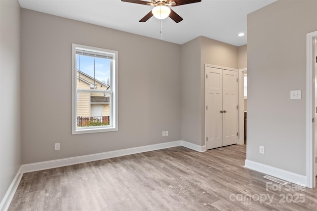 spare room with light hardwood / wood-style flooring and ceiling fan