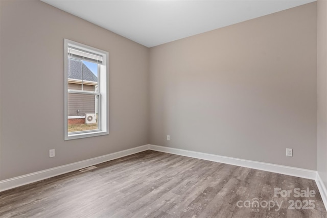 empty room with hardwood / wood-style flooring