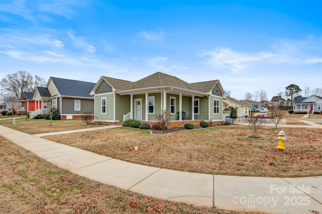 view of front of home featuring covered porch and a front yard