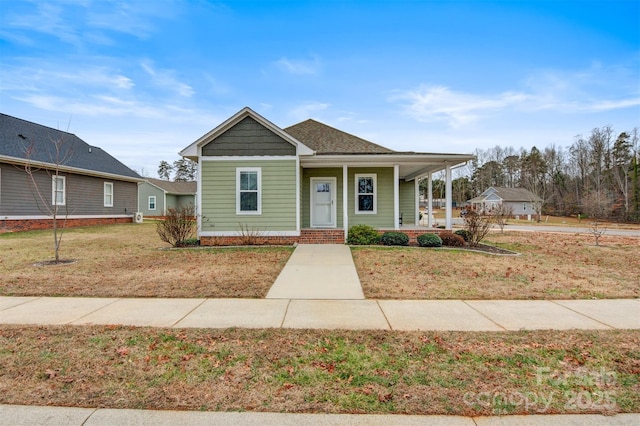 bungalow with a front yard and a porch