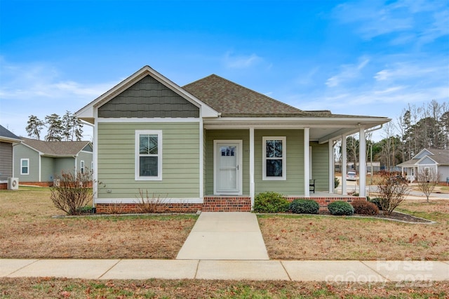 bungalow-style house with a front yard and a porch