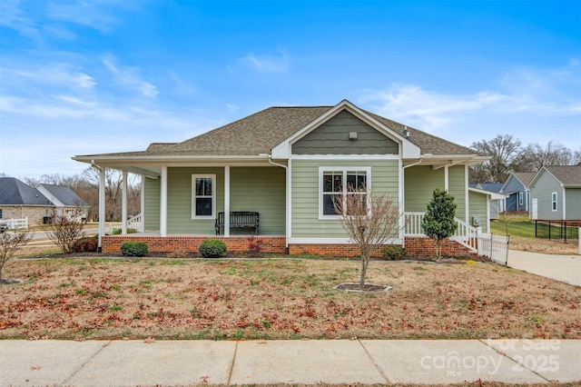 view of front of home with covered porch and a front yard