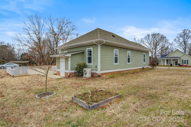 view of property exterior with ac unit and a yard