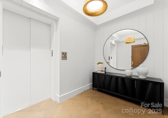 bathroom featuring vanity, parquet floors, and wooden walls