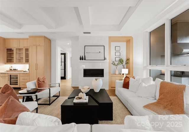 living room with beverage cooler, coffered ceiling, and beamed ceiling