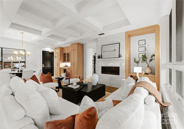 living room featuring a chandelier, a high end fireplace, beamed ceiling, and coffered ceiling