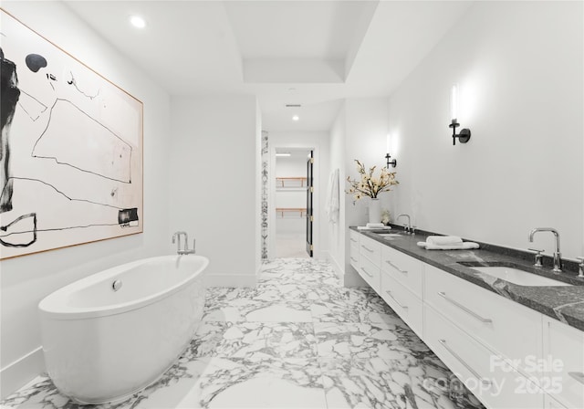 bathroom featuring vanity and a bath