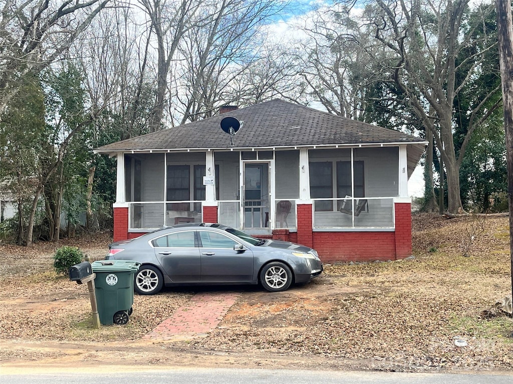 view of front of house featuring a sunroom