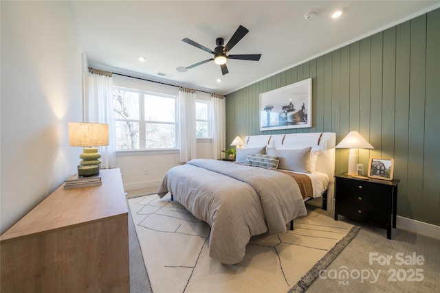 carpeted bedroom with ceiling fan, visible vents, and baseboards